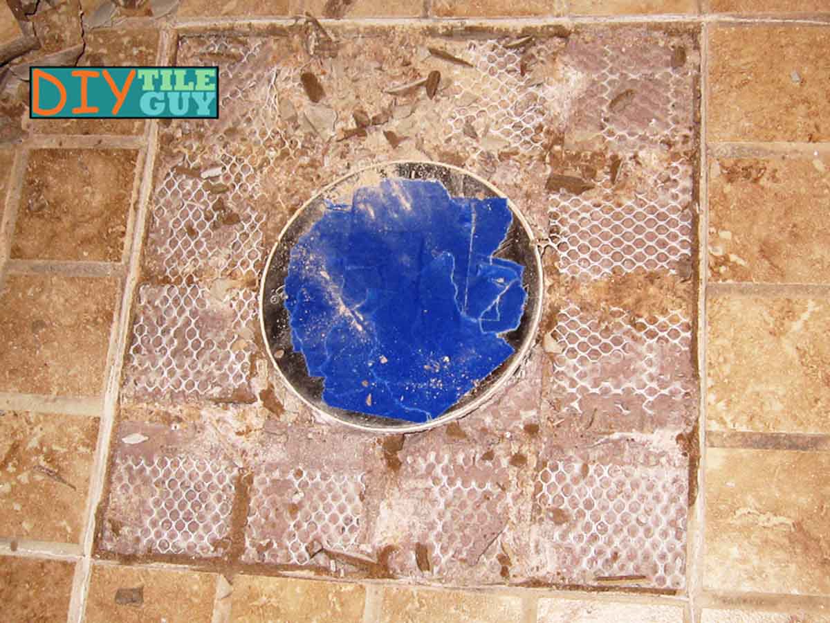 tiles are removed from around a shower drain